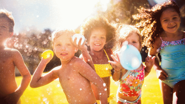 a picture of kids playing water games and water balloon games