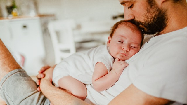 baby sleeping on dad who is wondering 'do babies dream'