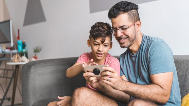 a little boy and his dad doing a scavenger hunt, which is one of the best indoor games