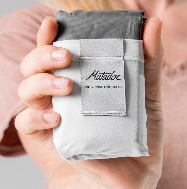 person holding the folding blanket