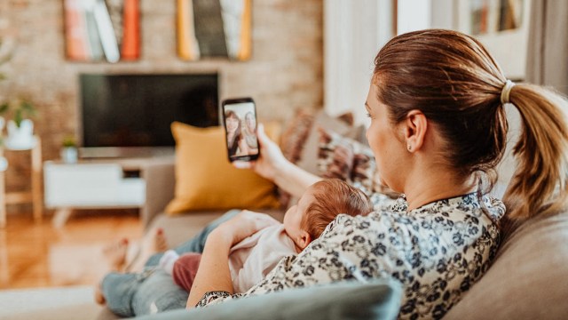 mom FaceTiming relatives with baby on her lap