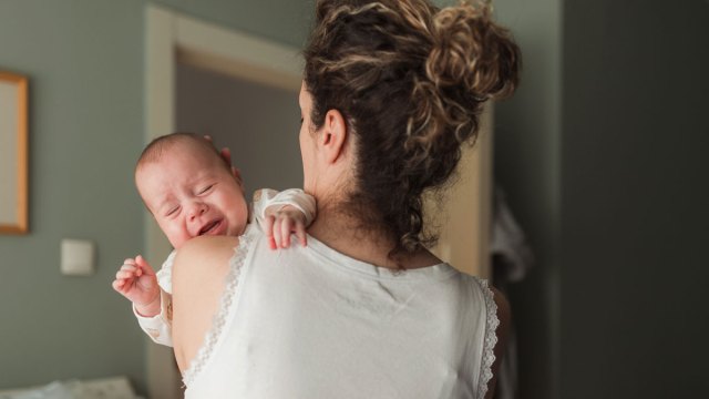 mom holding crying baby