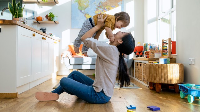 mom playing airplane with her baby, one of our games to keep baby busy