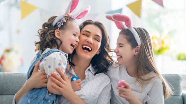 a picture of a mom and her daughters laughing at Easter jokes