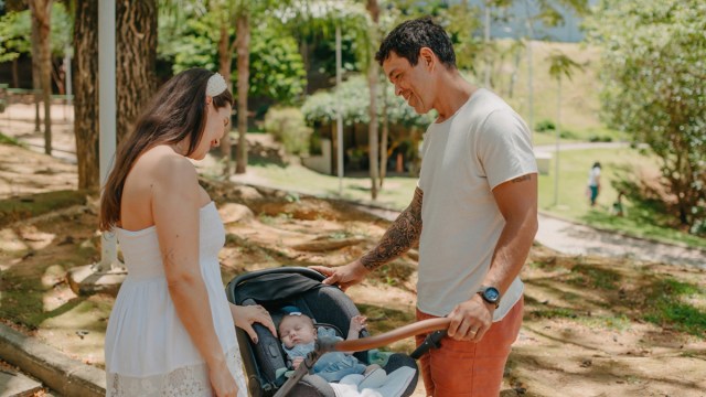 A couple at a park, which is one of the best places to have fun with babies.