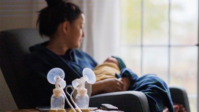 A mom sitting with her newborn after pumping according to breast pumping tips she found online