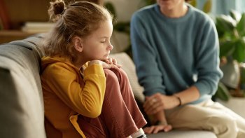 sad, angry kid on couch talking to her mom who is saying three yes statements to her