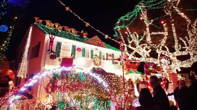 The Menashe house in West seattle covered in tiny lights for the holidays is a long-standing traditional Seattle Christmas lights display