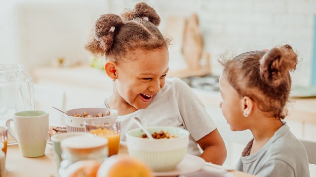 little sisters eating breakfast together for a story on breakfast ideas for toddlers