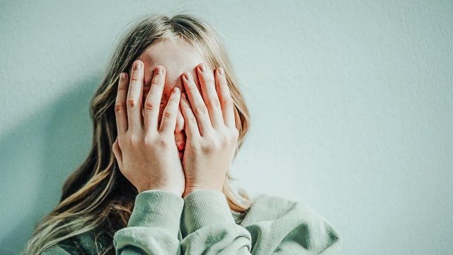 Gen Z teen covering her nose