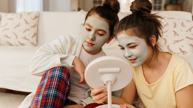 Two tweens wearing face masks and doing teen skincare