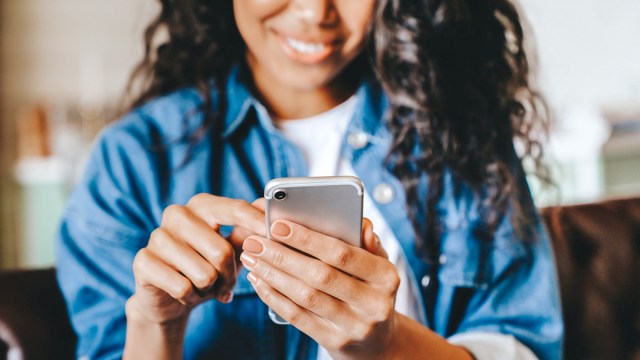 a woman sharing photos of her children on social media, a trend known as sharenting