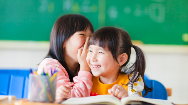 girls laughing at school jokes